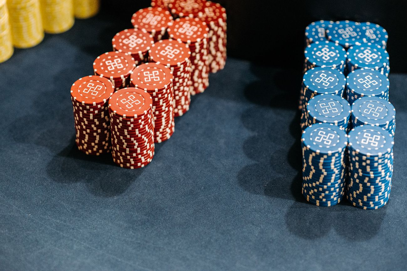 Stacks of red and blue casino chips on a gaming table